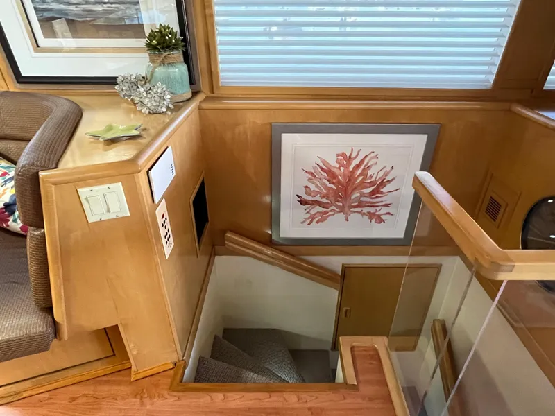 Slide: The Image of Interior of 1999 Hatteras 74 Sport Deck Motor Yacht with staircase and coral artwork. - 35