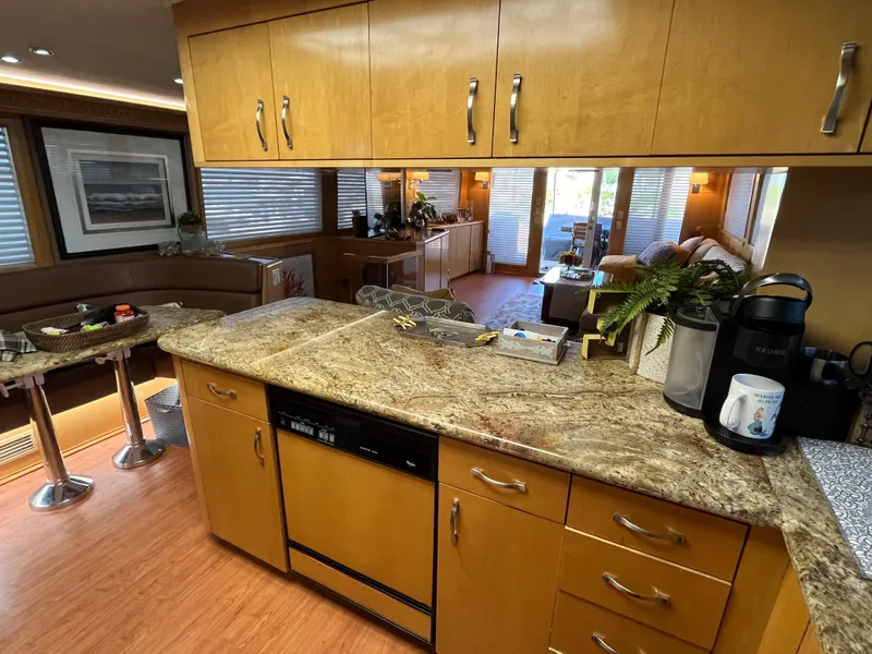 Slide: The Image of Interior of 1999 Hatteras 74 Sport Deck Motor Yacht with modern kitchen and living area. - 39