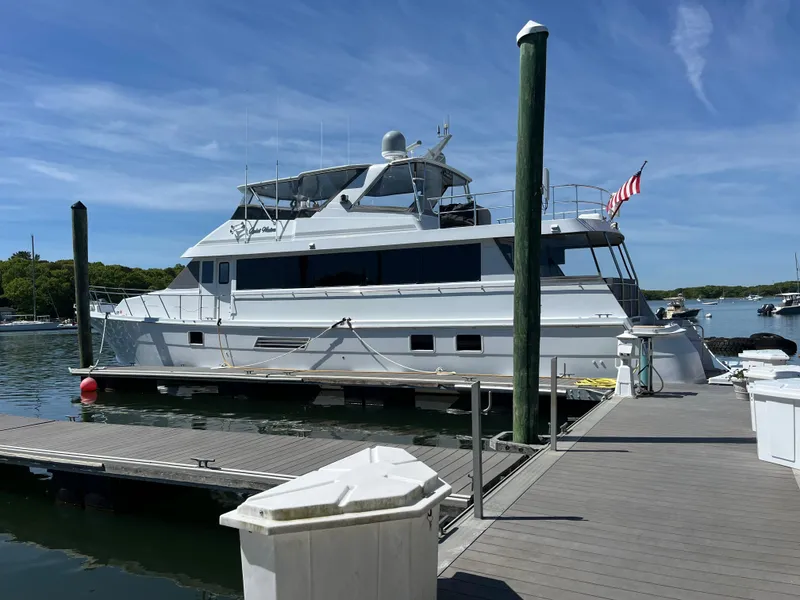 Slide: The Image of 1999 Hatteras 74 Sport Deck Motor Yacht docked at marina under clear blue sky. - 4