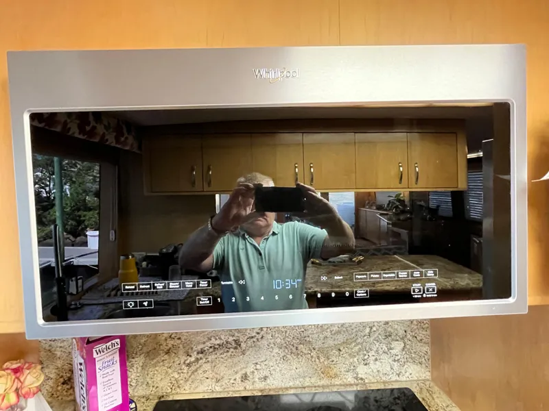 Slide: The Image of Reflection in Whirlpool microwave door showing kitchen interior and person taking photo. - 42
