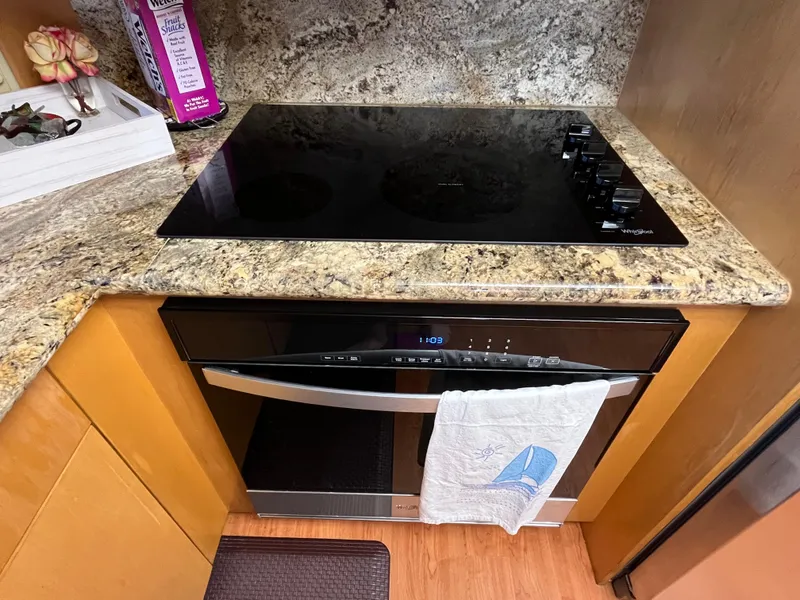 Slide: The Image of Modern kitchen with electric cooktop and oven in 1999 Hatteras 74 Sport Deck Motor Yacht. - 43