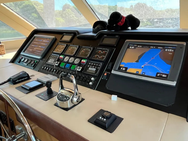Slide: The Image of Control panel of a 1999 Hatteras 74 Sport Deck Motor Yacht with navigation screens. - 44