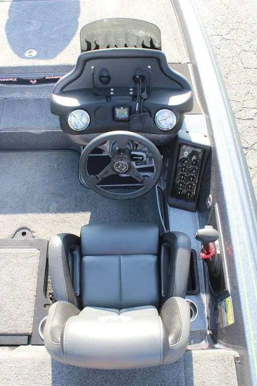 Slide: The Image of 2024 Phoenix 721 Pro XP boat cockpit with steering wheel and control panel. - 13