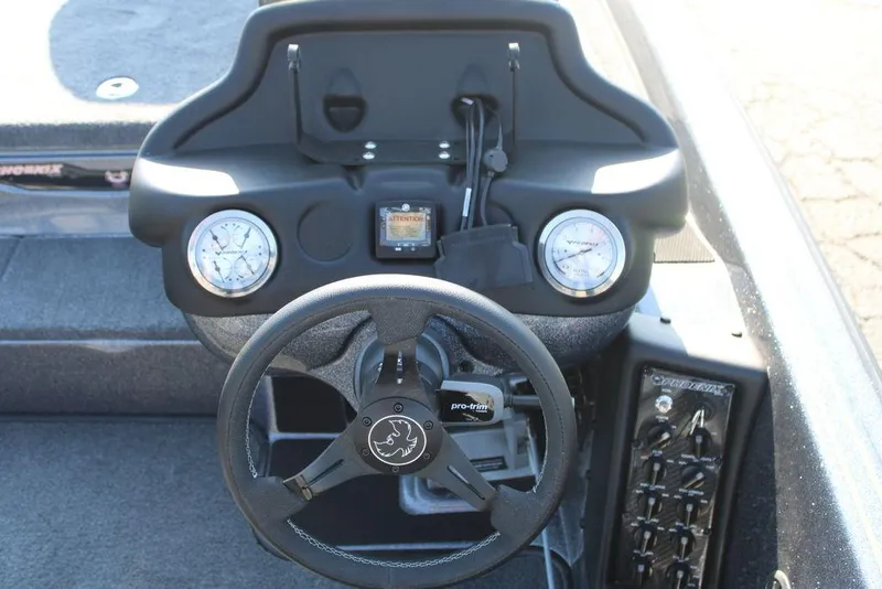 Slide: The Image of 2024 Phoenix 721 Pro XP boat dashboard with steering wheel and gauges. - 19