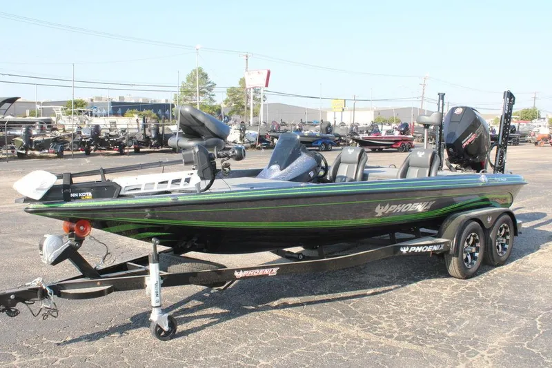 Slide: The Image of 2024 Phoenix 721 Pro XP bass boat on trailer in parking lot. - 2