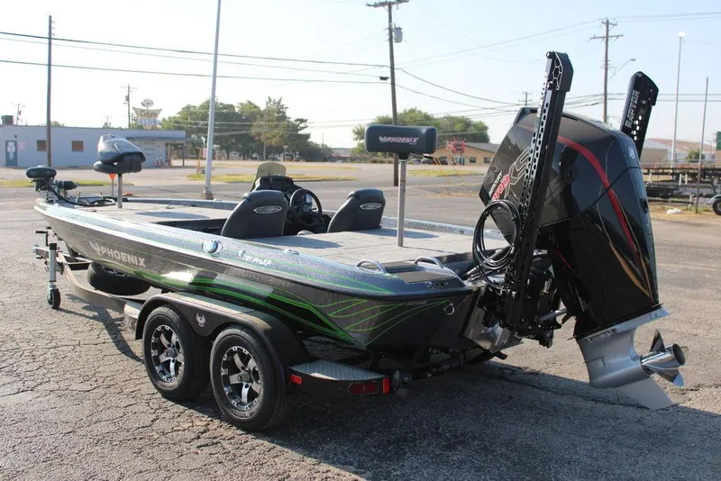 Slide: The Image of 2024 Phoenix 721 Pro XP bass boat with dual console and powerful outboard motor. - 4