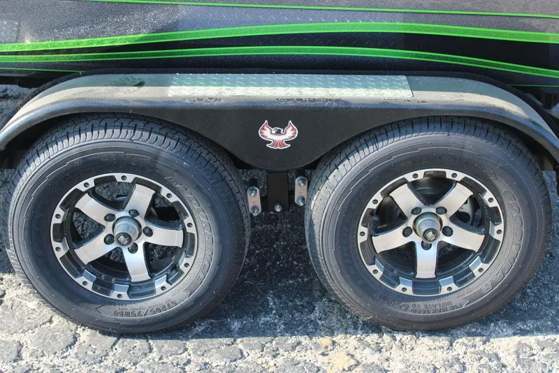 Slide: The Image of Dual wheels of a 2024 Phoenix 721 Pro XP boat trailer with green accents. - 9