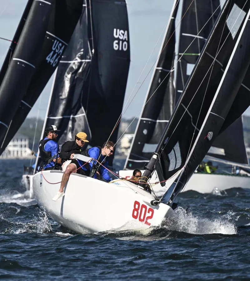 Slide: The Image of Sailboat race featuring 2009 Melges 24, number 802, with crew navigating choppy waters. - 3