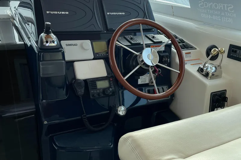 Slide: The Image of Helm of 2008 Tiara Yachts 4300 Sovran with navigation equipment and wooden steering wheel. - 2