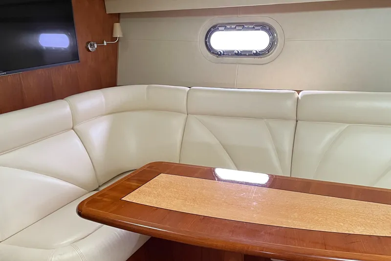Slide: The Image of Luxurious interior of 2008 Tiara Yachts 4300 Sovran with leather seating and wooden table. - 20
