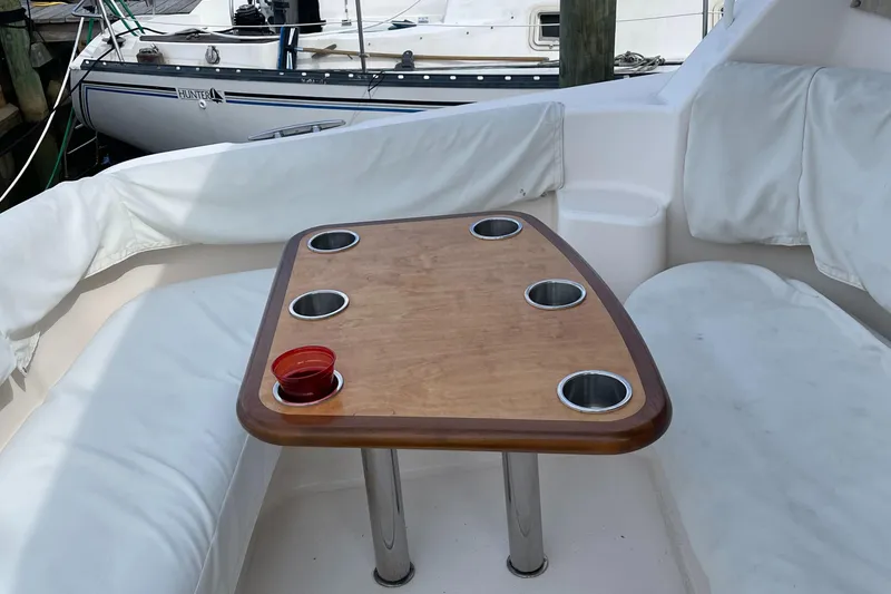 Slide: The Image of 2008 Tiara Yachts 4300 Sovran interior with wooden table and cushioned seating. - 9