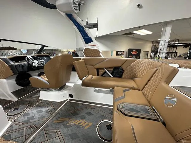 Slide: The Image of 2024 Tigé 22RZX boat interior with luxurious tan seating and modern dashboard. - 10