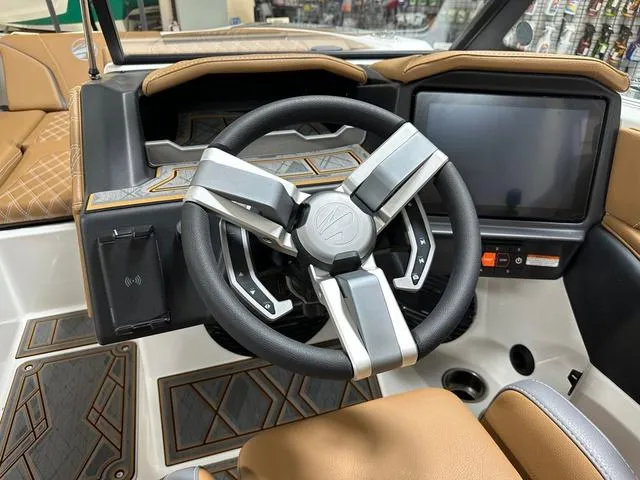 Slide: The Image of 2024 Tigé 22RZX boat dashboard with modern steering wheel and touchscreen display. - 13