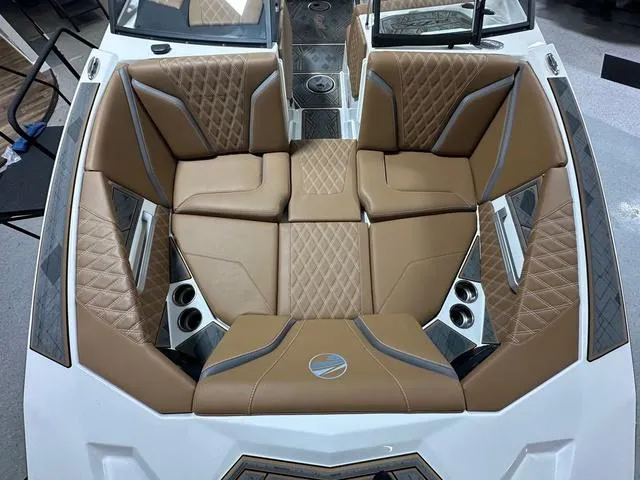 Slide: The Image of 2024 Tigé 22RZX boat interior with luxurious brown seating and diamond stitching. - 15