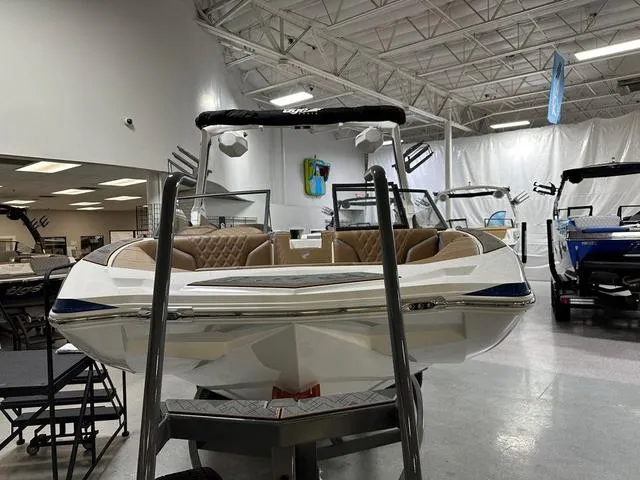 Slide: The Image of 2024 Tigé 22RZX boat displayed in a showroom with modern interior design. - 4