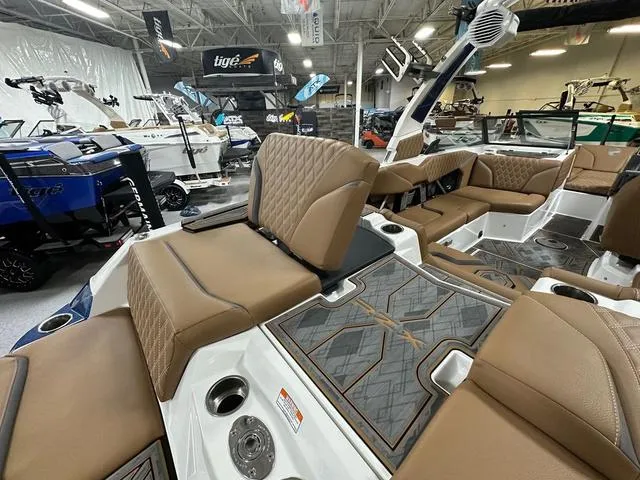 Slide: The Image of 2024 Tigé 22RZX boat interior with luxurious brown seating and modern design. - 7