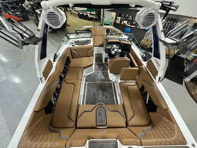 Slide: The Image of 2024 Tigé 22RZX boat interior with luxurious brown seating and advanced audio system. - 8