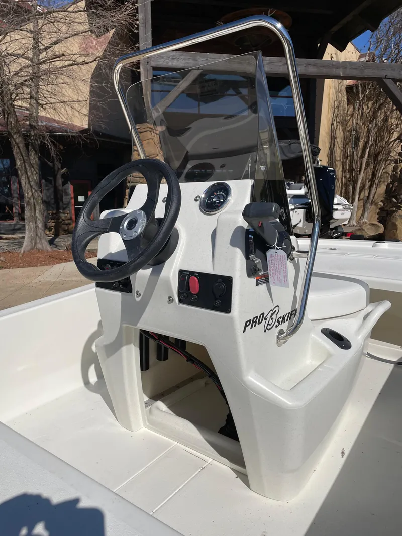 Slide: The Image of 2024 Mako Pro Skiff 13 CC center console with steering wheel and controls. - 3