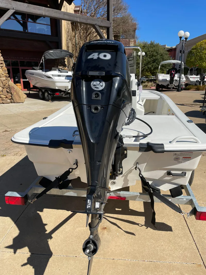 Slide: The Image of 2024 Mako Pro Skiff 13 CC with 40 HP outboard motor on trailer. - 4