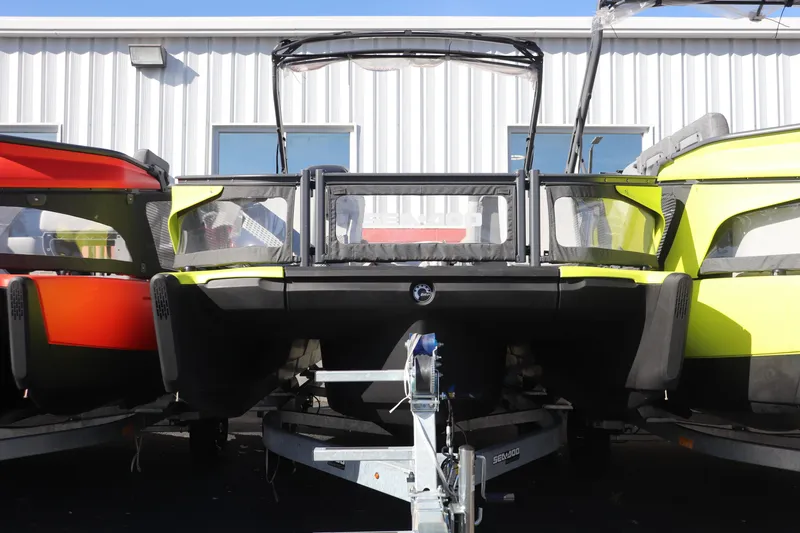 The Image of 2024 Sea-Doo Switch® Sport 21-230 pontoon boats on trailers, vibrant colors, outdoor display. - 0