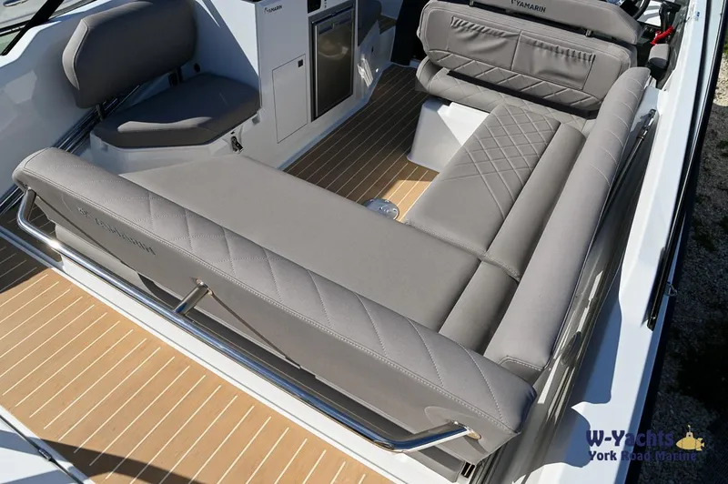 Slide: The Image of Yamarin 80 2024 boat interior with gray cushioned seating and wooden flooring. - 12
