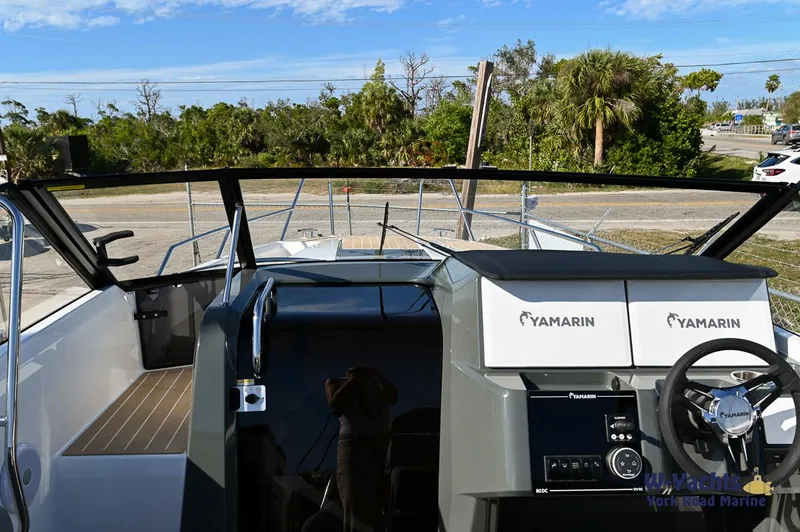 Slide: The Image of 2024 Yamarin 80 boat cockpit with steering wheel and dashboard. - 14