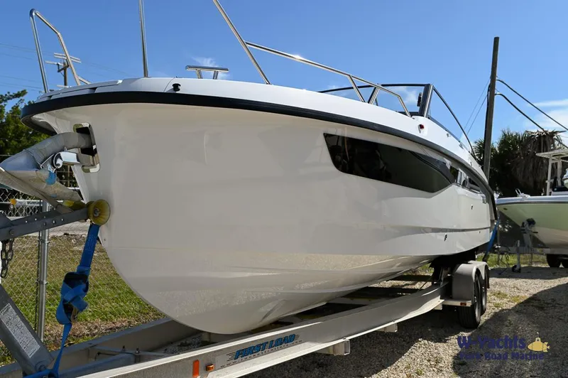 Slide: The Image of 2024 Yamarin 80 boat on a trailer, side view, outdoors. - 23