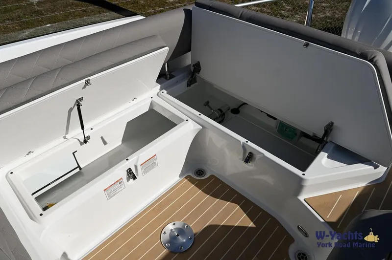 Slide: The Image of Open storage compartments on the 2024 Yamarin 80 boat with cushioned seating. - 27