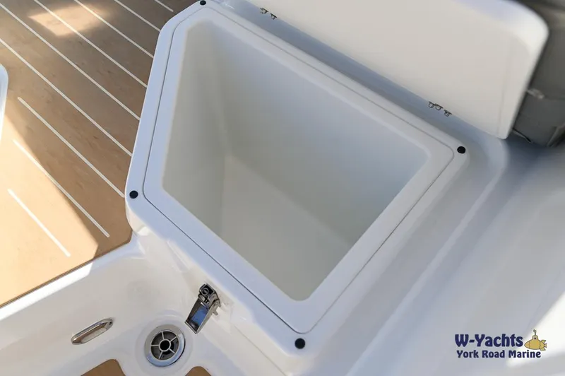 Slide: The Image of Yamarin 80 boat storage compartment, 2024 model, open lid, wooden deck, W-Yachts branding. - 28