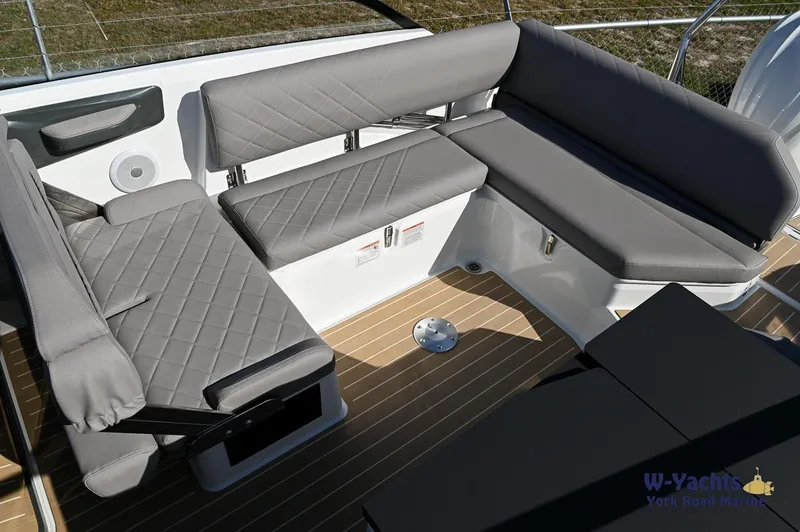 Slide: The Image of 2024 Yamarin 80 boat interior with grey cushioned seating and wooden flooring. - 34