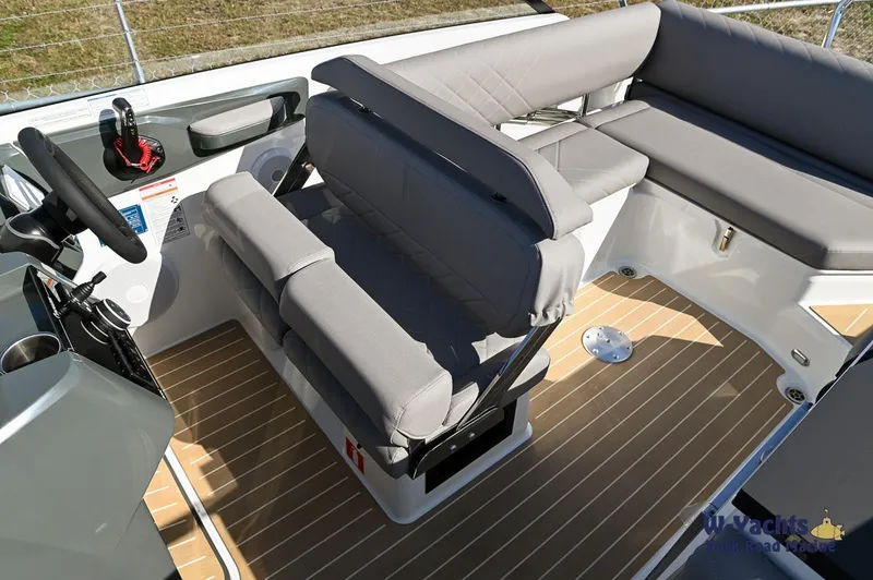 Slide: The Image of Yamarin 80 2024 boat interior with grey seating and wooden flooring. - 35