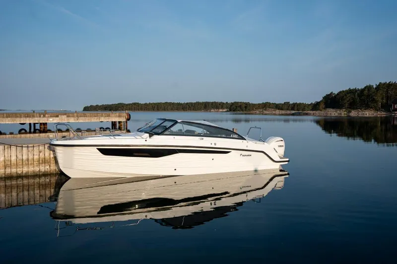 Slide: The Image of 2024 Yamarin 80 boat docked on calm water. - 8