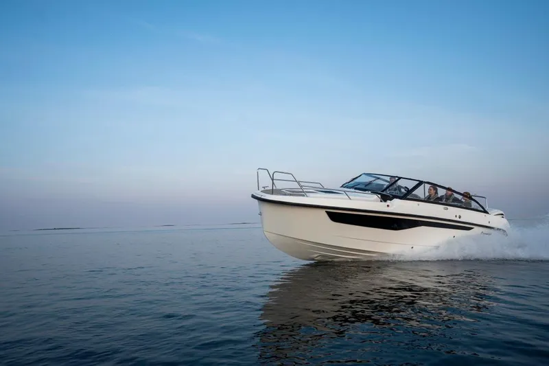 Slide: The Image of 2024 Yamarin 80 boat cruising on calm water at sunset. - 9