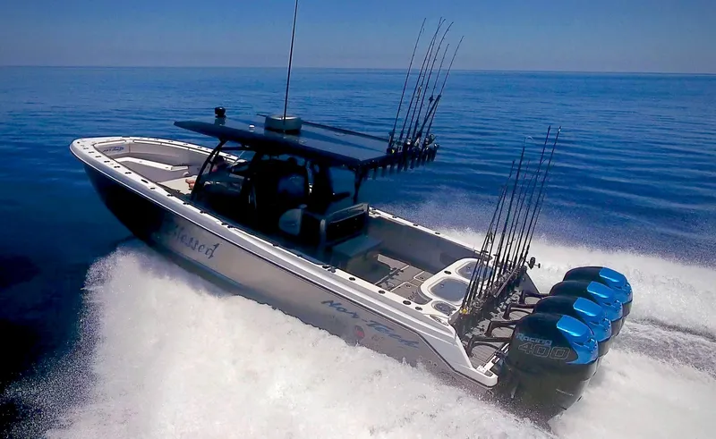 Slide: The Image of 2024 Nor-Tech 392 Superfish boat speeding on the ocean with multiple fishing rods. - 1