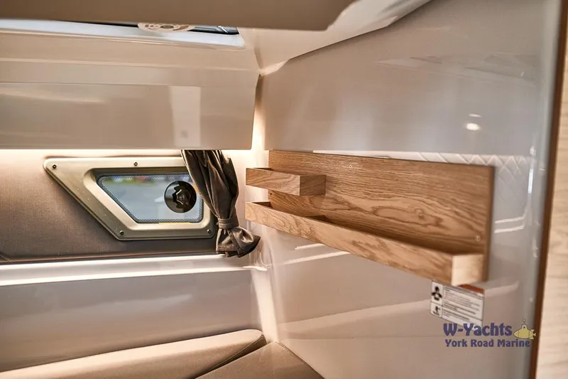 Slide: The Image of Interior cabin of 2023 Yamarin 88 boat with window and wooden shelf. - 11
