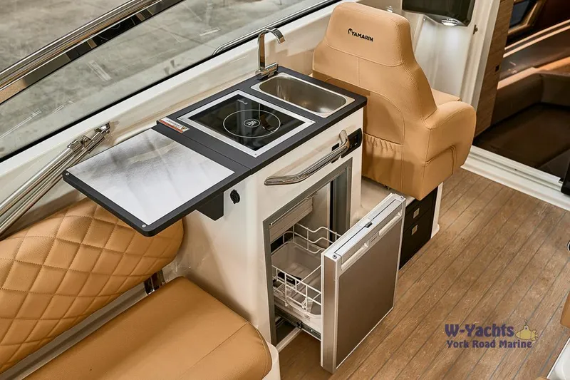 Slide: The Image of Modern Yamarin 88 boat kitchen with sink, stove, and seating, 2023 model. - 13