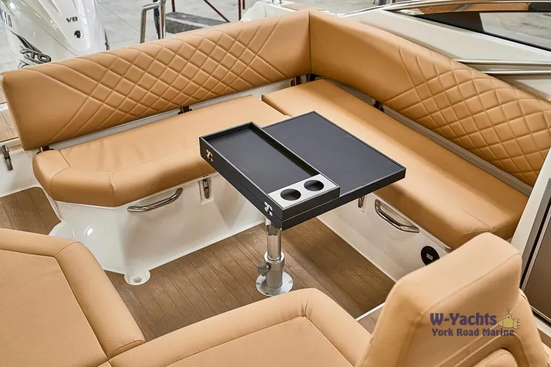 Slide: The Image of Luxurious seating area on the 2023 Yamarin 88 boat with tan upholstery and a sleek table. - 15