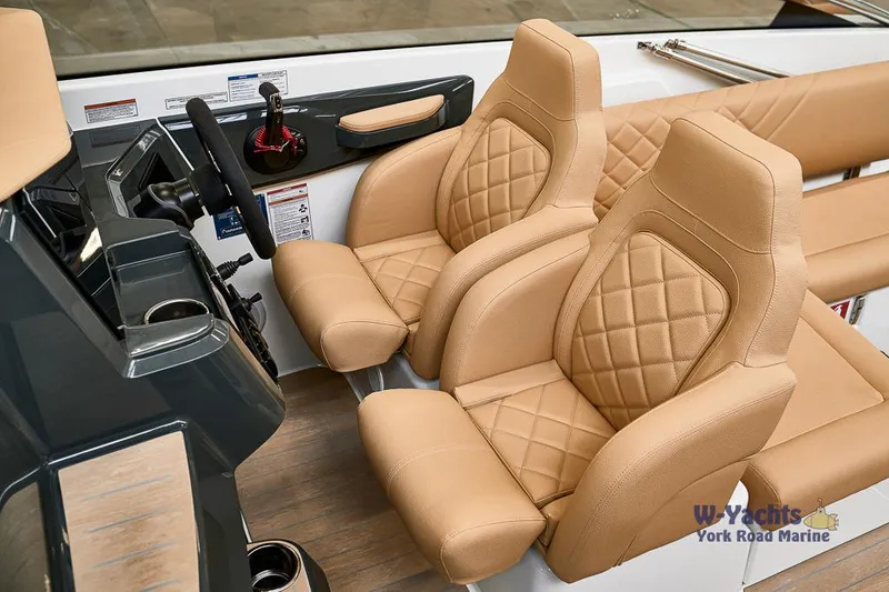 Slide: The Image of Yamarin 88 2023 boat interior with tan quilted seats and modern dashboard. - 4