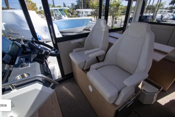 Slide: The Image of Interior of 2025 Quarken 35 boat with modern seating and steering console. - 12
