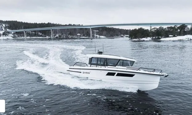 Slide: The Image of 2024 Quarken 35 boat cruising on a scenic waterway with a bridge in the background. - 4