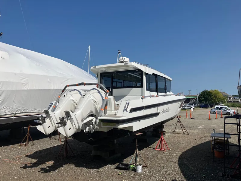 Slide: The Image of 2025 Quarken 35 boat on dry dock with twin outboard engines. - 8