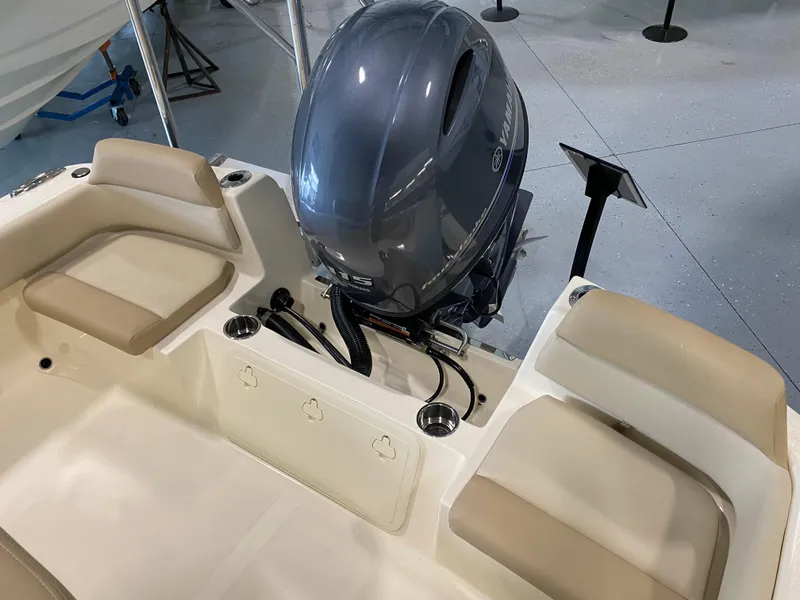 Slide: The Image of 2025 Scout 195 Sportfish boat with outboard motor and cushioned seating. - 5