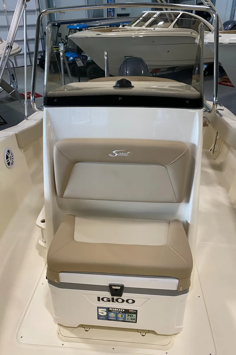Slide: The Image of 2025 Scout 195 Sportfish boat interior with beige seating and Igloo cooler. - 8