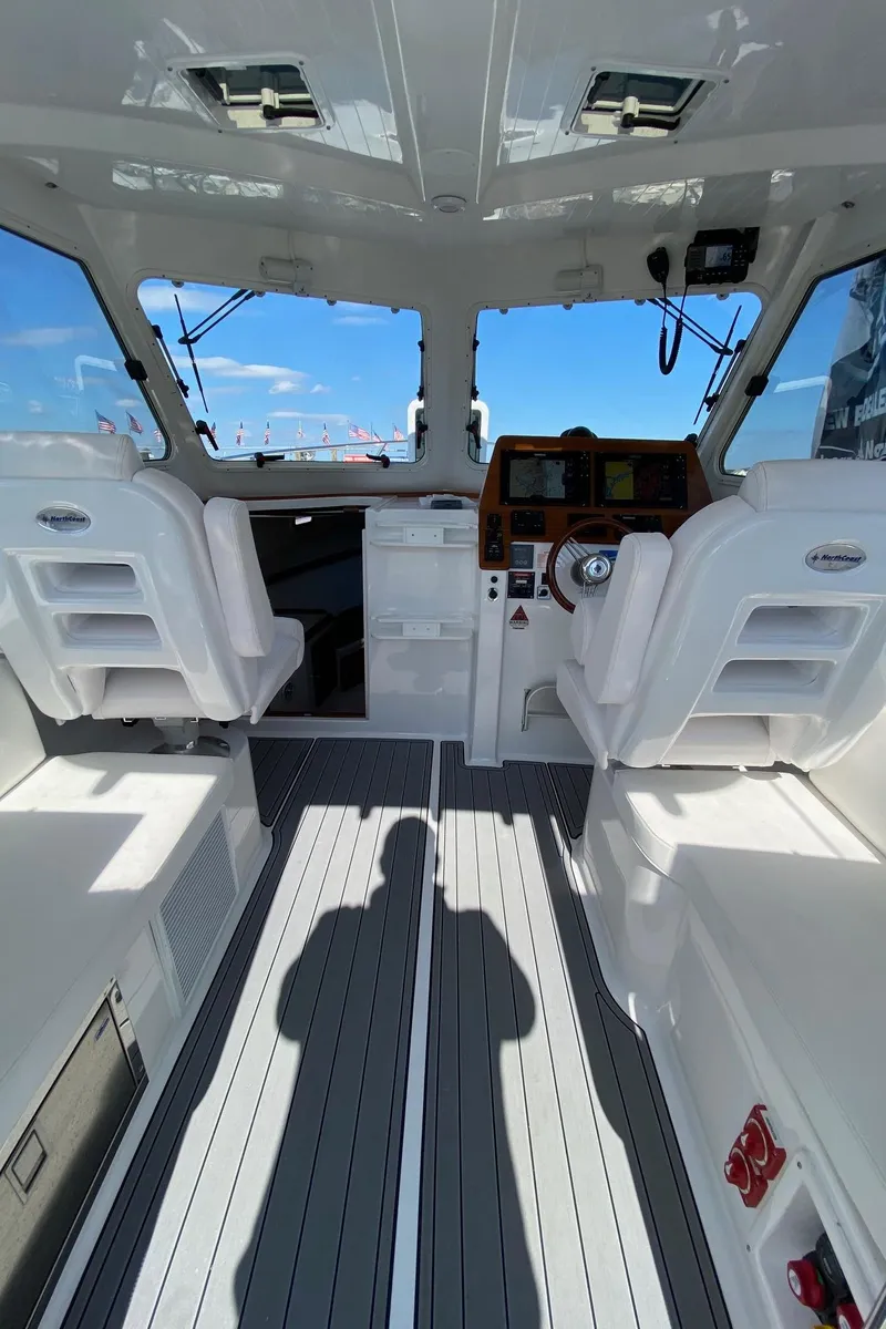 Slide: The Image of Interior of 2022 NorthCoast 315 boat with modern cockpit and seating. - 8