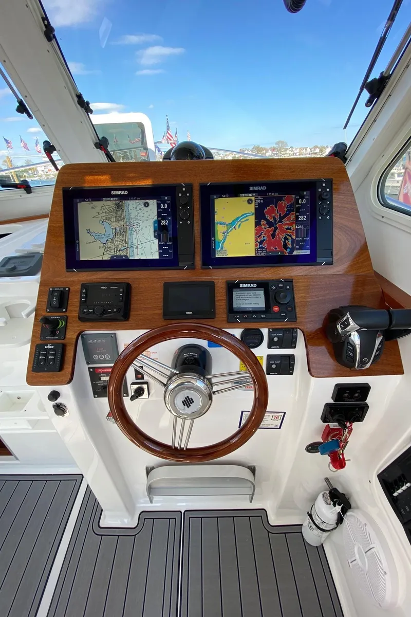 Slide: The Image of 2022 NorthCoast 315 boat helm with navigation screens and controls. - 9
