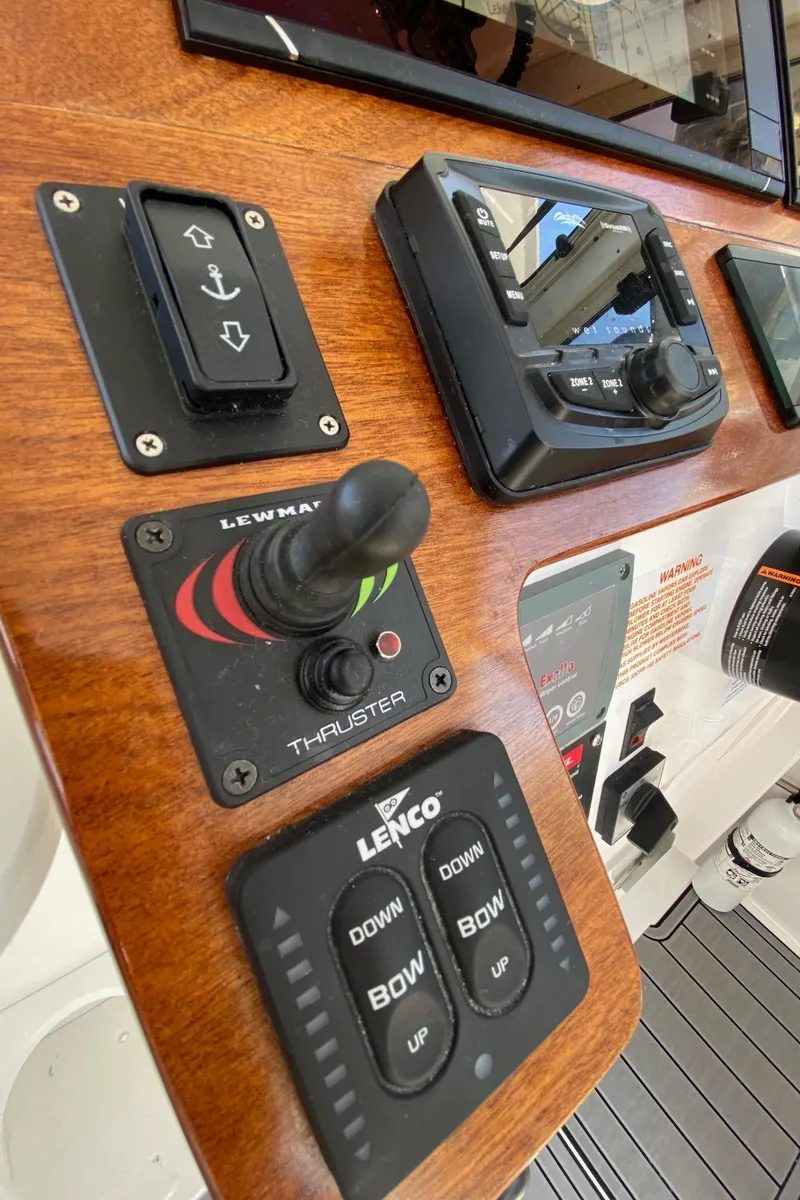 Slide: The Image of Control panel of a 2022 NorthCoast 315 boat with thruster and trim tab controls. - 16