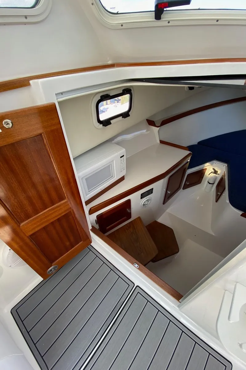 Slide: The Image of Interior cabin of 2022 NorthCoast 315 boat with wooden accents and seating area. - 17