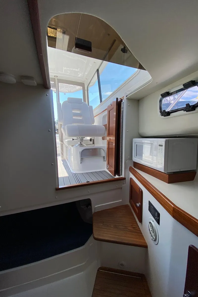 Slide: The Image of Interior of 2022 NorthCoast 315 boat with seating and microwave. - 19