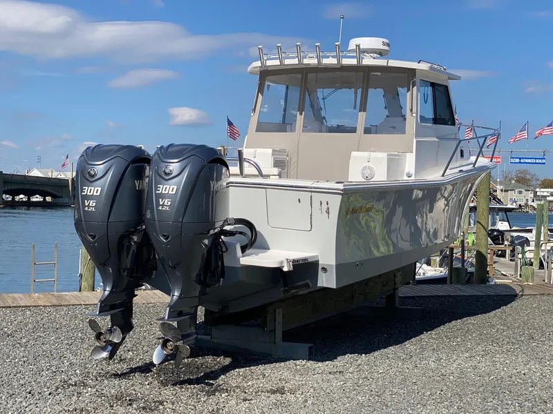 Slide: The Image of 2022 NorthCoast 315 boat with twin Yamaha 300 V6 engines on a dock. - 3