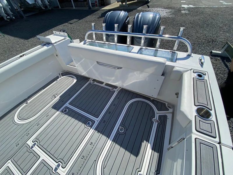 Slide: The Image of 2022 NorthCoast 315 boat deck with dual outboard motors and rod holders. - 4
